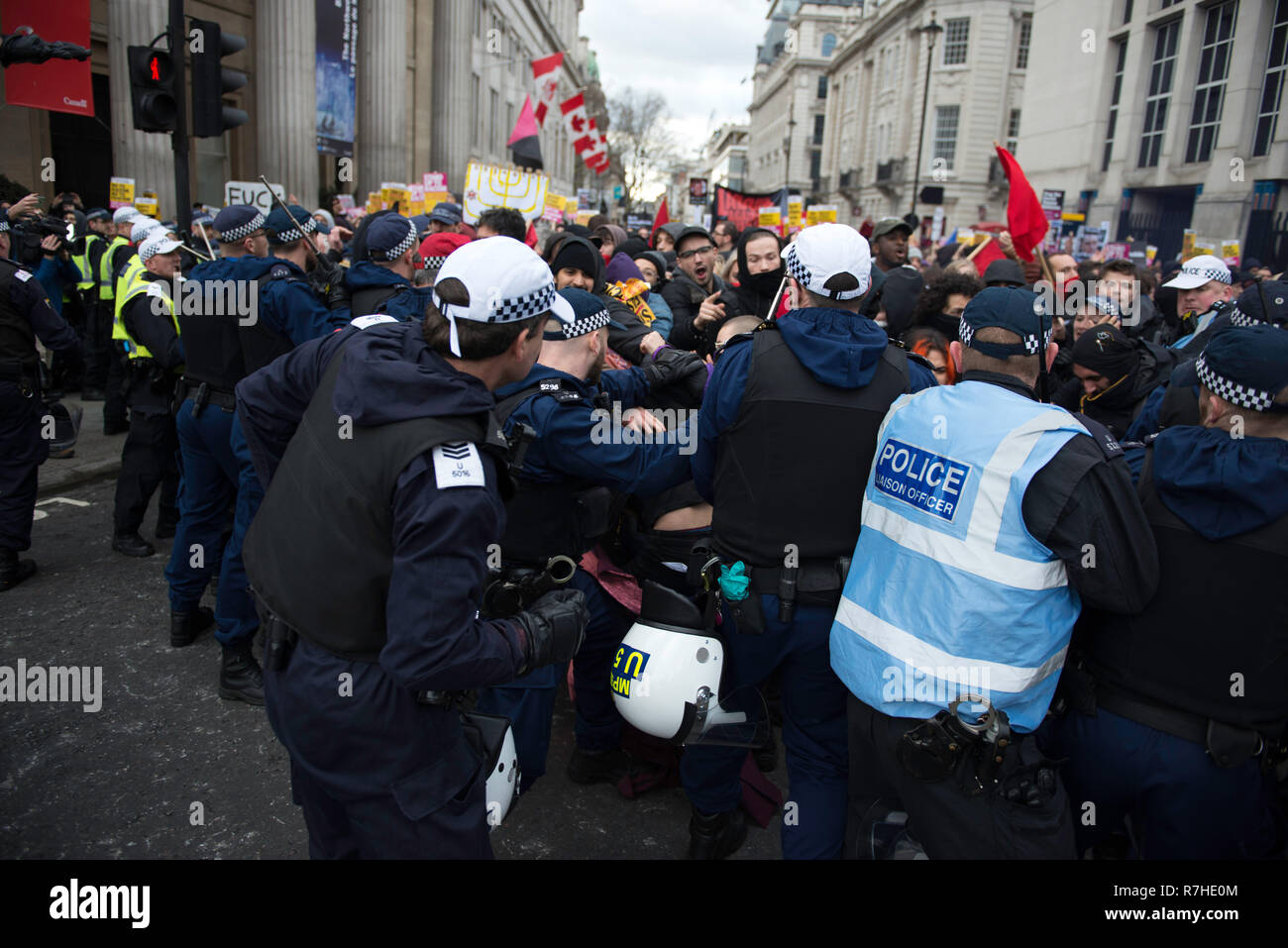Police officers contain a group of protesters marching to Whitehall during the demonstration against the 'Brexit Betrayal March'.  Thousands of people took to the streets in central London to march against the 'Brexit Betrayal March' organised by Tommy Robinson and UKIP. Counter Protesters made their way from Portland Place to Whitehall, where speakers addressed the crowd. During the counter demonstration, there was a strong police presence. A group of counter protesters, who became separated from the main protest, were corralled by police to avoid an encounter with a group of Tommy Robinson / Stock Photo