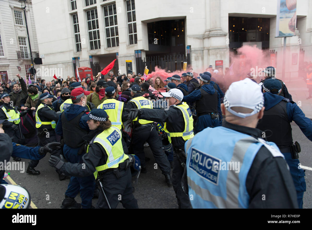 Police officers contain protesters marching to Whitehall during the demonstration against the 'Brexit Betrayal March'.  Thousands of people took to the streets in central London to march against the 'Brexit Betrayal March' organised by Tommy Robinson and UKIP. Counter Protesters made their way from Portland Place to Whitehall, where speakers addressed the crowd. During the counter demonstration, there was a strong police presence. A group of counter protesters, who became separated from the main protest, were corralled by police to avoid an encounter with a group of Tommy Robinson / UKIP suppo Stock Photo