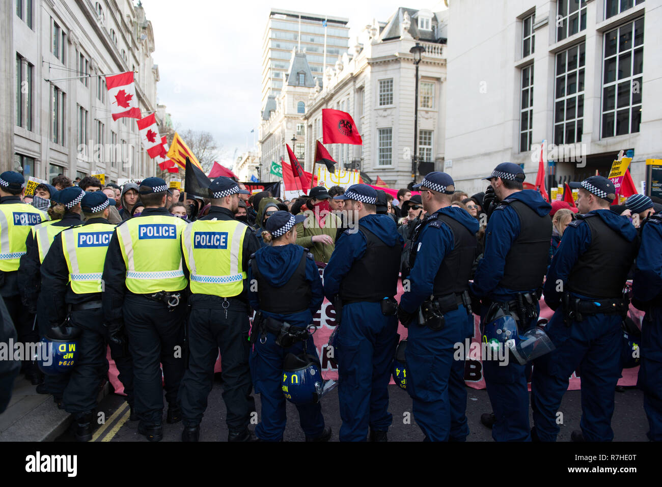 Police officers cordon seen in front of the counter protesters during a demonstration against the 'Brexit Betrayal March'.  Thousands of people took to the streets in central London to march against the 'Brexit Betrayal March' organised by Tommy Robinson and UKIP. Counter Protesters made their way from Portland Place to Whitehall, where speakers addressed the crowd. During the counter demonstration, there was a strong police presence. A group of counter protesters, who became separated from the main protest, were corralled by police to avoid an encounter with a group of Tommy Robinson / UKIP s Stock Photo