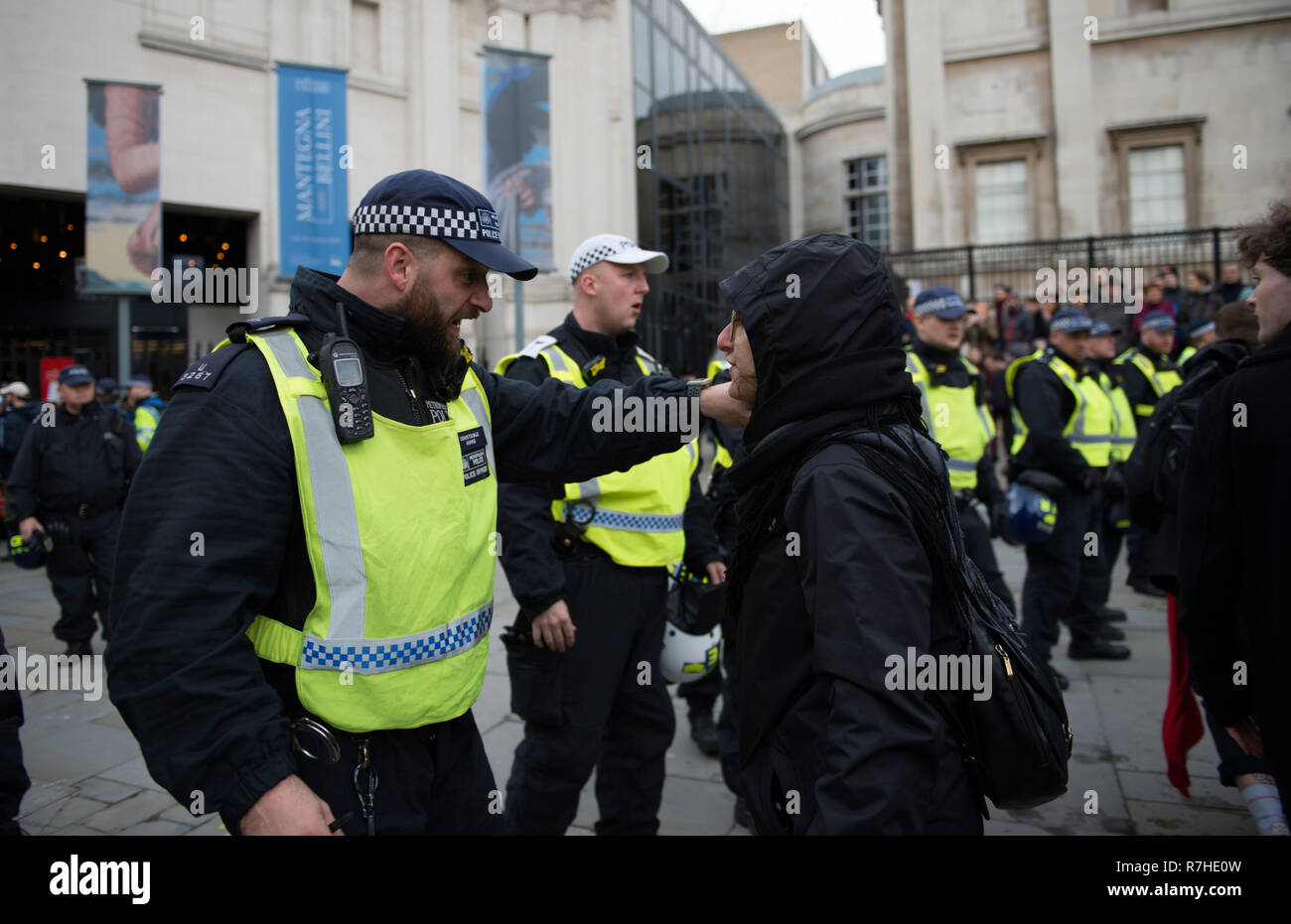 Police officer arguing with a protester during the demonstration against the 'Brexit Betrayal March'.  Thousands of people took to the streets in central London to march against the 'Brexit Betrayal March' organised by Tommy Robinson and UKIP. Counter Protesters made their way from Portland Place to Whitehall, where speakers addressed the crowd. During the counter demonstration, there was a strong police presence. A group of counter protesters, who became separated from the main protest, were corralled by police to avoid an encounter with a group of Tommy Robinson / UKIP supporters. Stock Photo