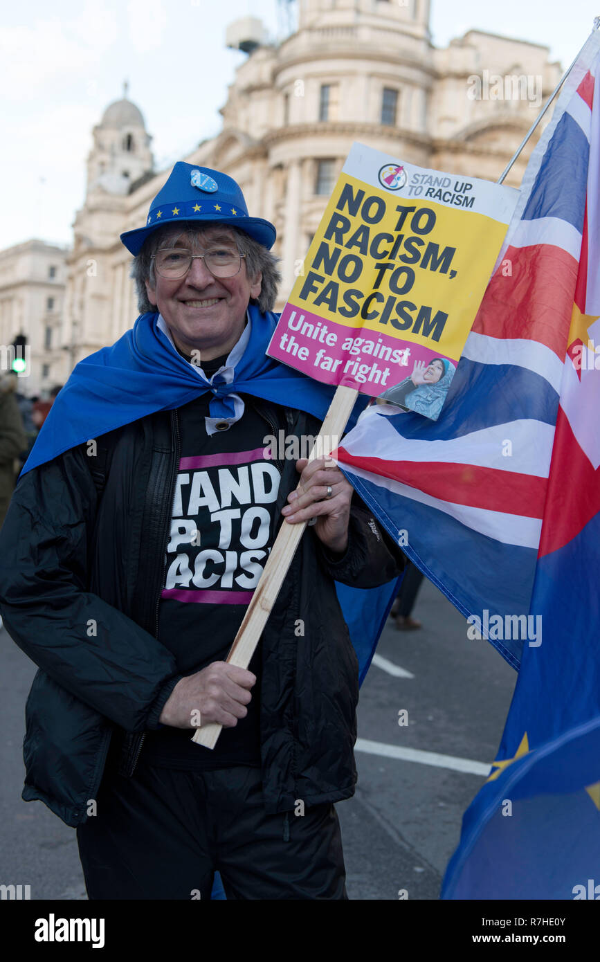 Counter protester seen holding a placard and a UK flag during the demonstration against the 'Brexit Betrayal March'.  Thousands of people took to the streets in central London to march against the 'Brexit Betrayal March' organised by Tommy Robinson and UKIP. Counter Protesters made their way from Portland Place to Whitehall, where speakers addressed the crowd. During the counter demonstration, there was a strong police presence. A group of counter protesters, who became separated from the main protest, were corralled by police to avoid an encounter with a group of Tommy Robinson / UKIP support Stock Photo