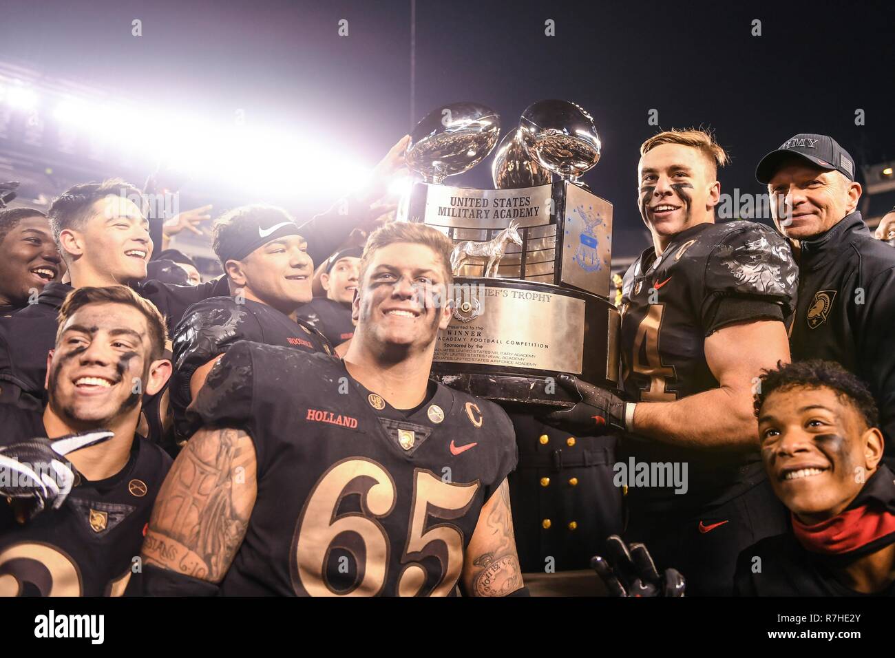 West Point football players and head coach, Jeff Monken, right, pose with the Commander-in-Chiefs Trophy as they celebrate their  victory over Navy in the 119th Army Navy game at Lincoln Financial Field December 8, 2018 in Philadelphia, Pennsylvania. The Army Black Knights trounced Navy 17-10 in the third straight win over their rival. Stock Photo