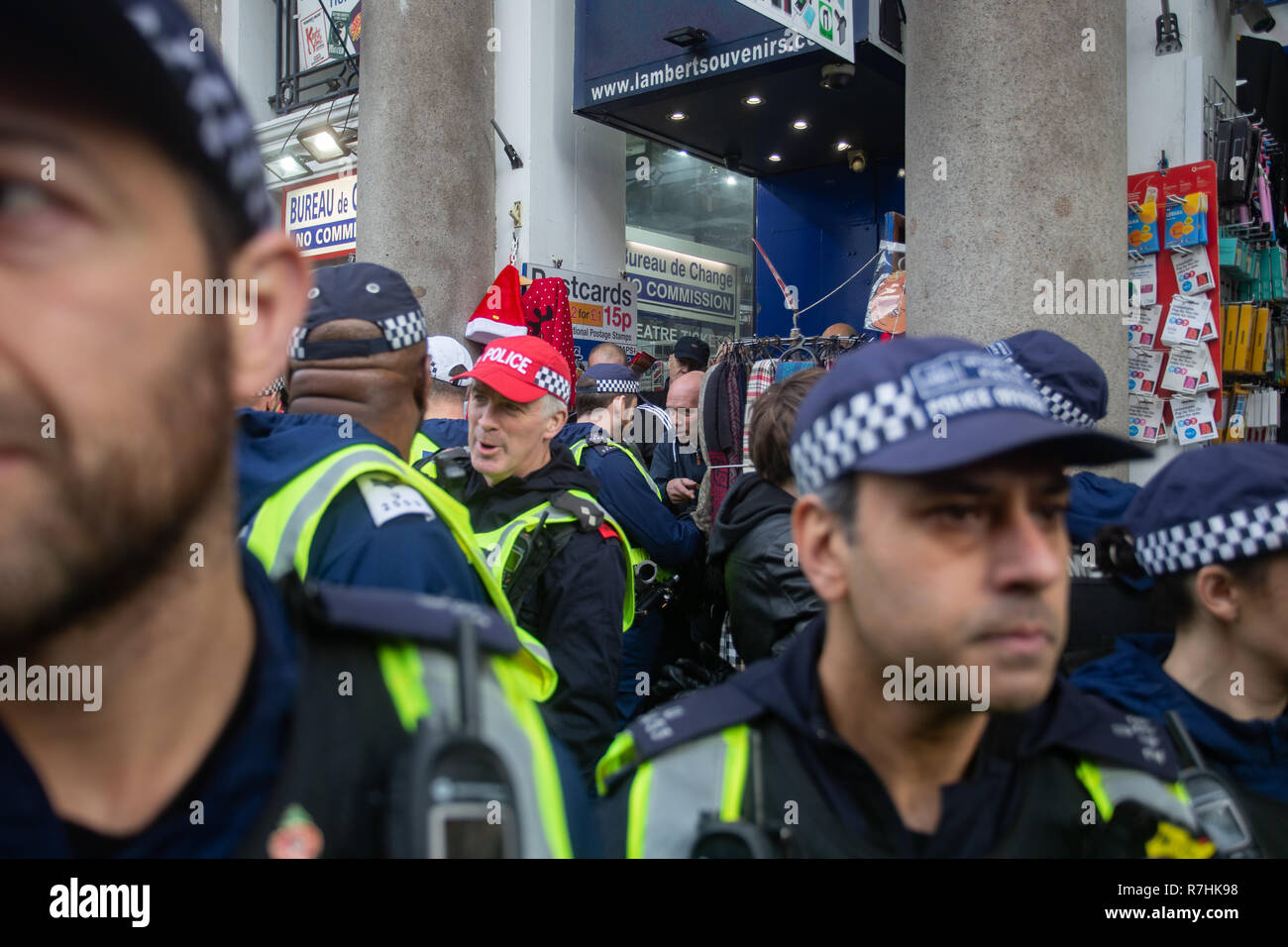 Police shield UKIP demonstrators inside a souvenir shop following a scuffle with Anti-Facist demonstrators.   3,000 Pro-Brexit demonstrators and 15,000 Anti-Facist counter demonstrators took to the streets of London to voice their stance on the deal ahead of the key Brexit vote in parliament this Tuesday. Stock Photo