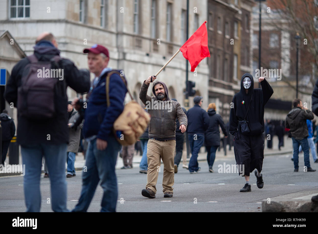 Two Anti-Facist demonstrators head towards the main rally.   3,000 Pro-Brexit demonstrators and 15,000 Anti-Facist counter demonstrators took to the streets of London to voice their stance on the deal ahead of the key Brexit vote in parliament this Tuesday. Stock Photo