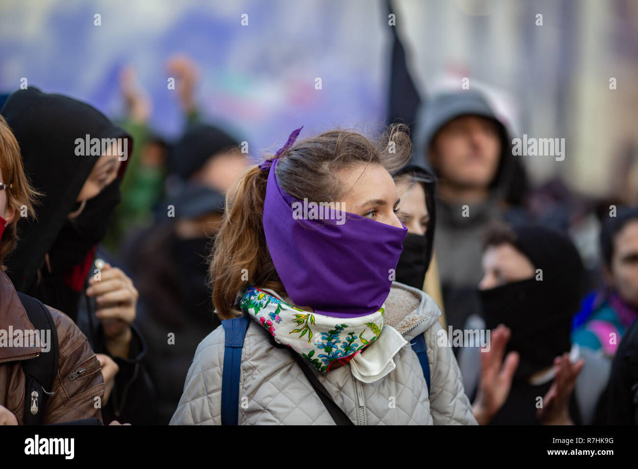 An Anti-Facist demonstrator covers her mouth as purple smoke billows behind her.  3,000 Pro-Brexit demonstrators and 15,000 Anti-Facist counter demonstrators took to the streets of London to voice their stance on the deal ahead of the key Brexit vote in parliament this Tuesday. Stock Photo