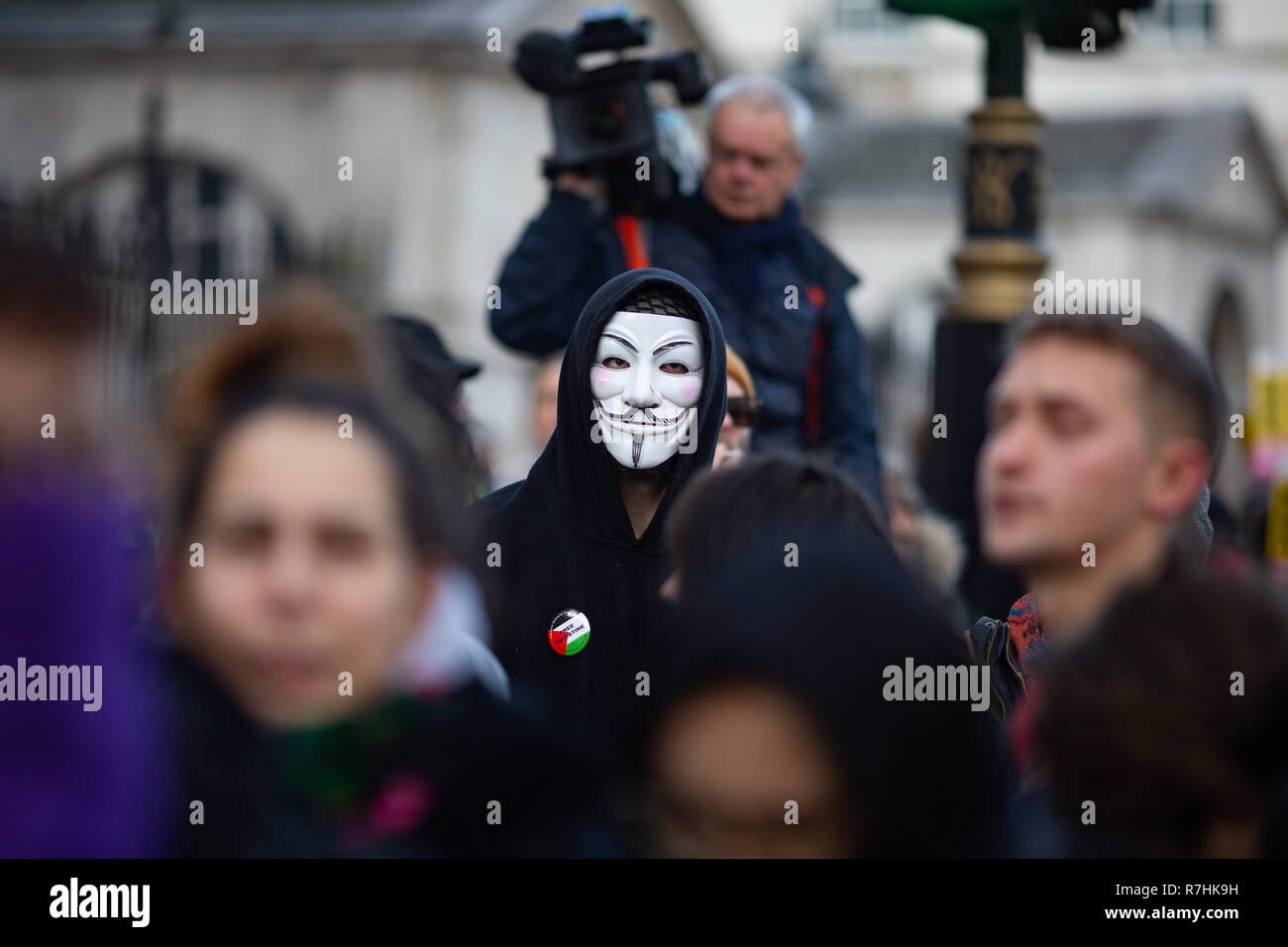 A masked Anti-facist demonstrator looks onwards as the demonstration commences.   3,000 Pro-Brexit demonstrators and 15,000 Anti-Facist counter demonstrators took to the streets of London to voice their stance on the deal ahead of the key Brexit vote in parliament this Tuesday. Stock Photo