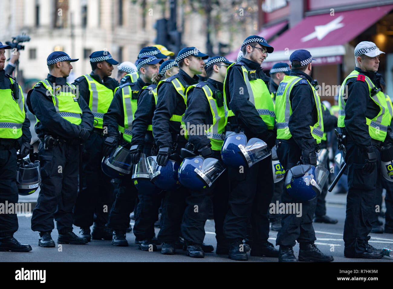 Police huddle close as the demonstrations draw to a close.   3,000 Pro-Brexit demonstrators and 15,000 Anti-Facist counter demonstrators took to the streets of London to voice their stance on the deal ahead of the key Brexit vote in parliament this Tuesday. Stock Photo