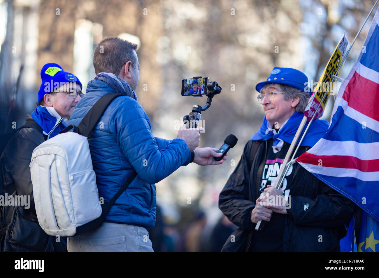 An Anti-Facist demonstrator wearing a European Union hat is interviewed during the rally.  3,000 Pro-Brexit demonstrators and 15,000 Anti-Facist counter demonstrators took to the streets of London to voice their stance on the deal ahead of the key Brexit vote in parliament this Tuesday. Stock Photo