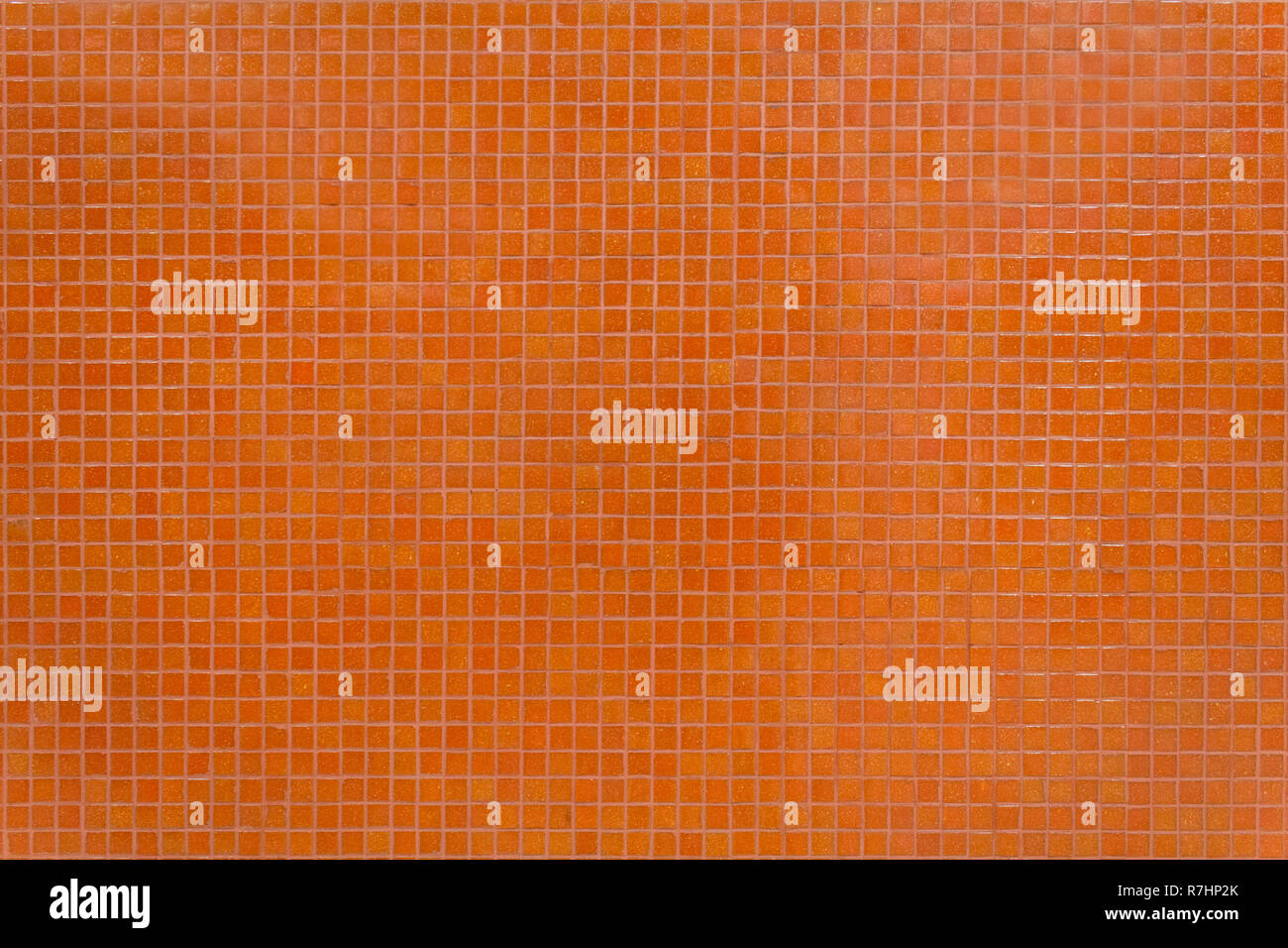 Wall orange tiles with little mosaic squares. Stock Photo
