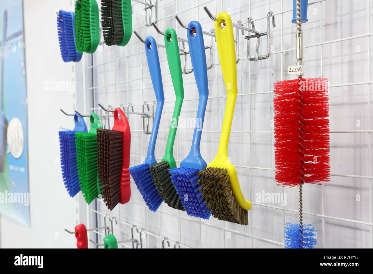 plastic cleaning brushes in supermarket hanger ; close up Stock Photo