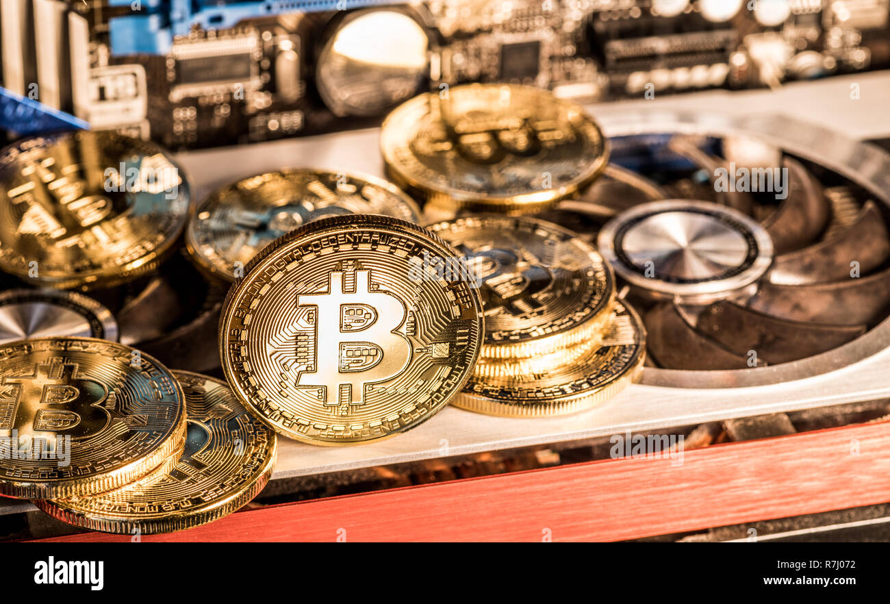 Shiny physical bitcoins and record-keeping equipment. Mining farm. Stock Photo