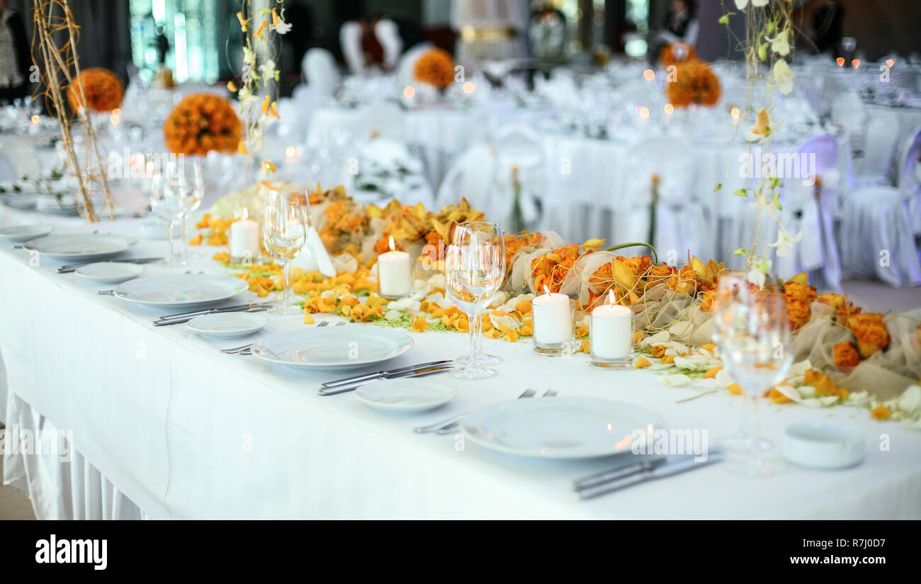 Holiday table setting decorated with flowers and candles Stock Photo ...