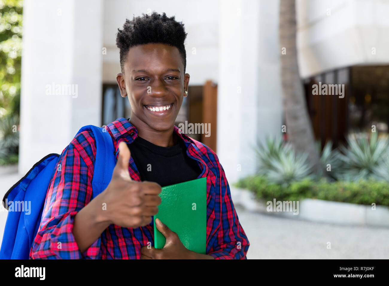 Successful african american male student with book outdoor in the city Stock Photo