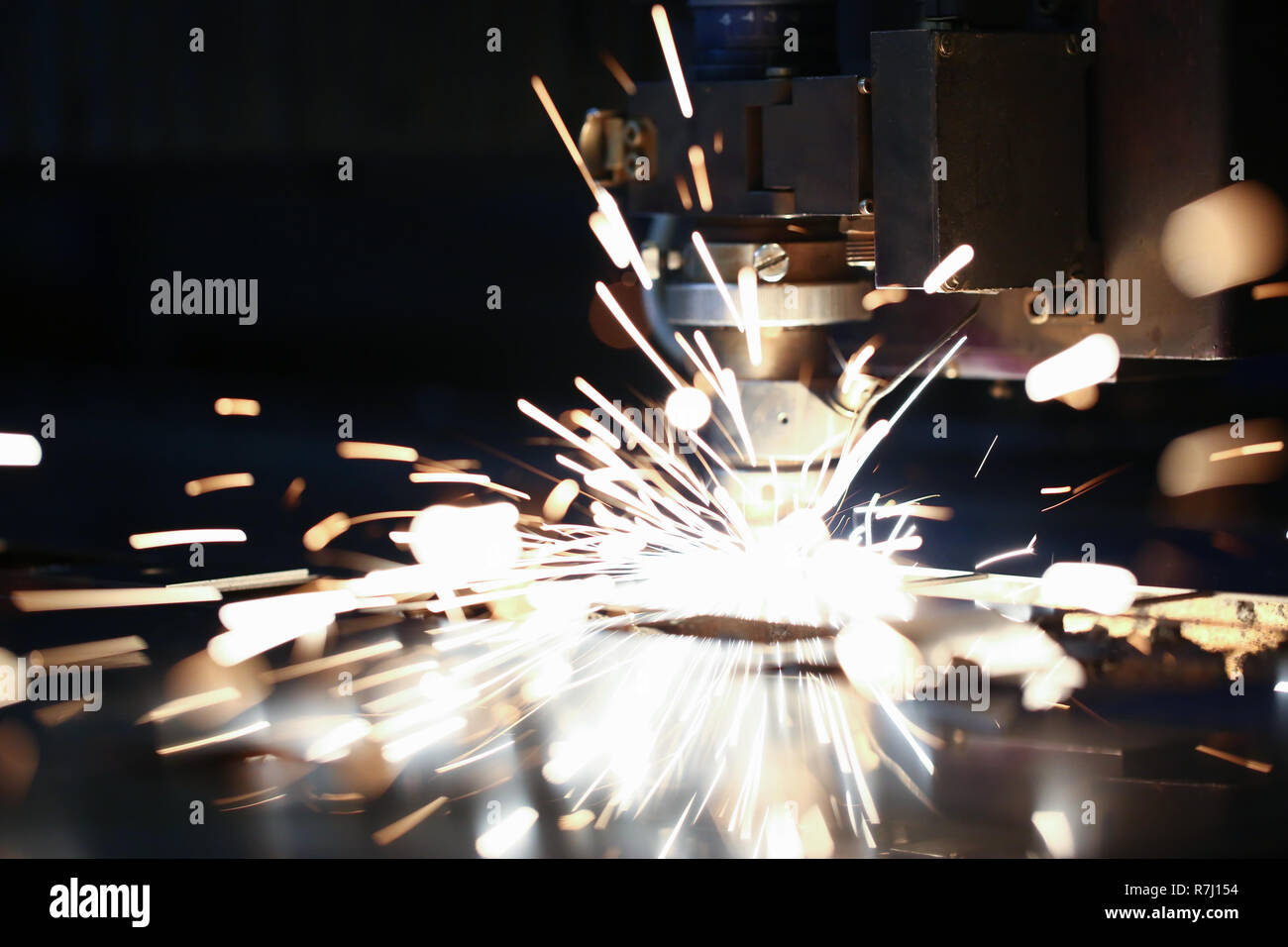 Sparks fly out machine head for metal processing Stock Photo