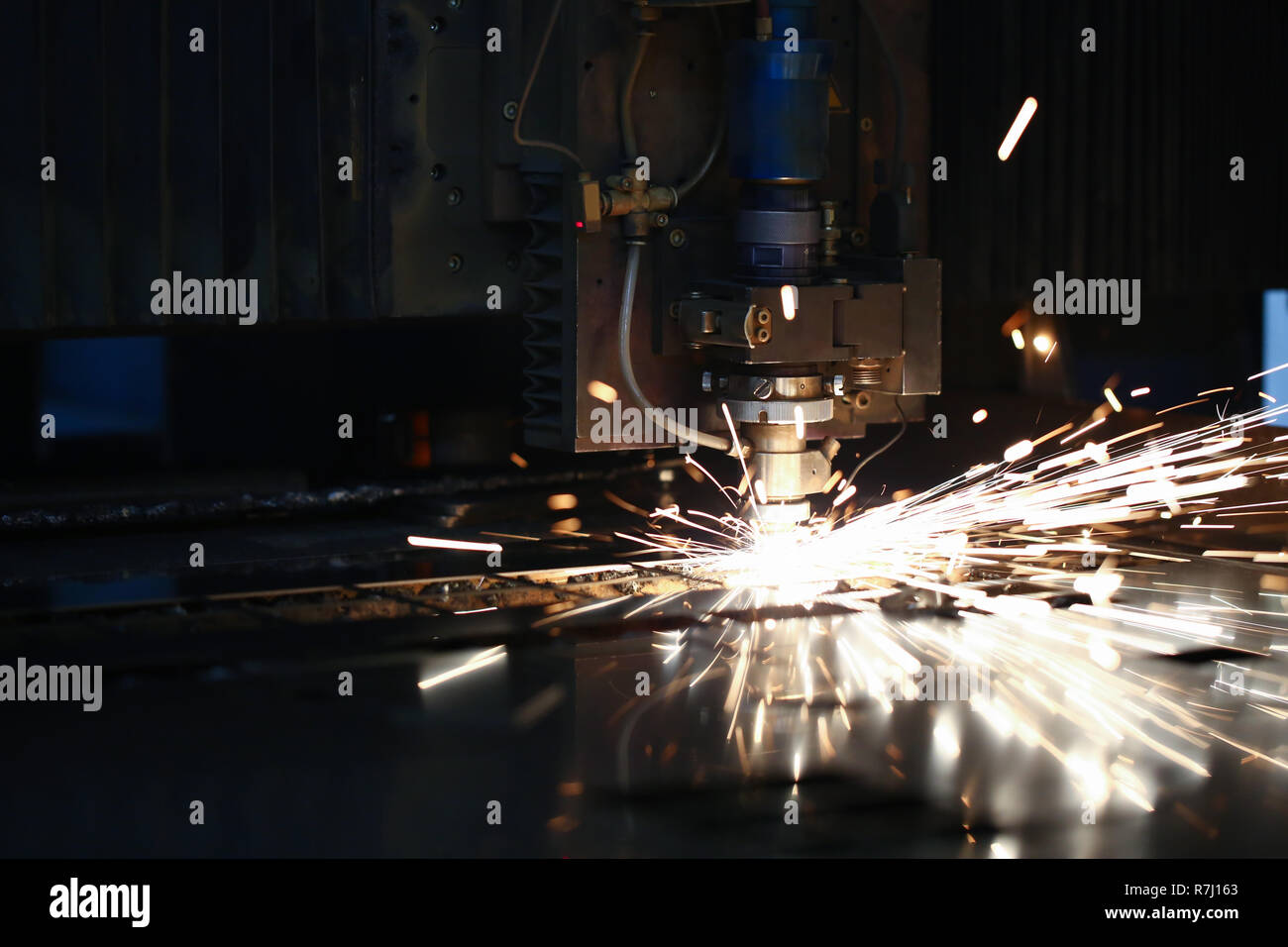 Sparks fly out machine head for metal processing Stock Photo