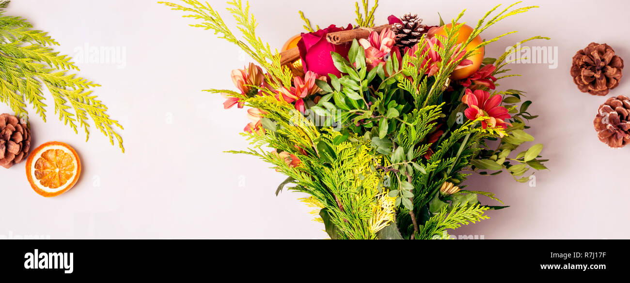 Winter Christmas bouquet of coniferous twigs and flowers. Stock Photo