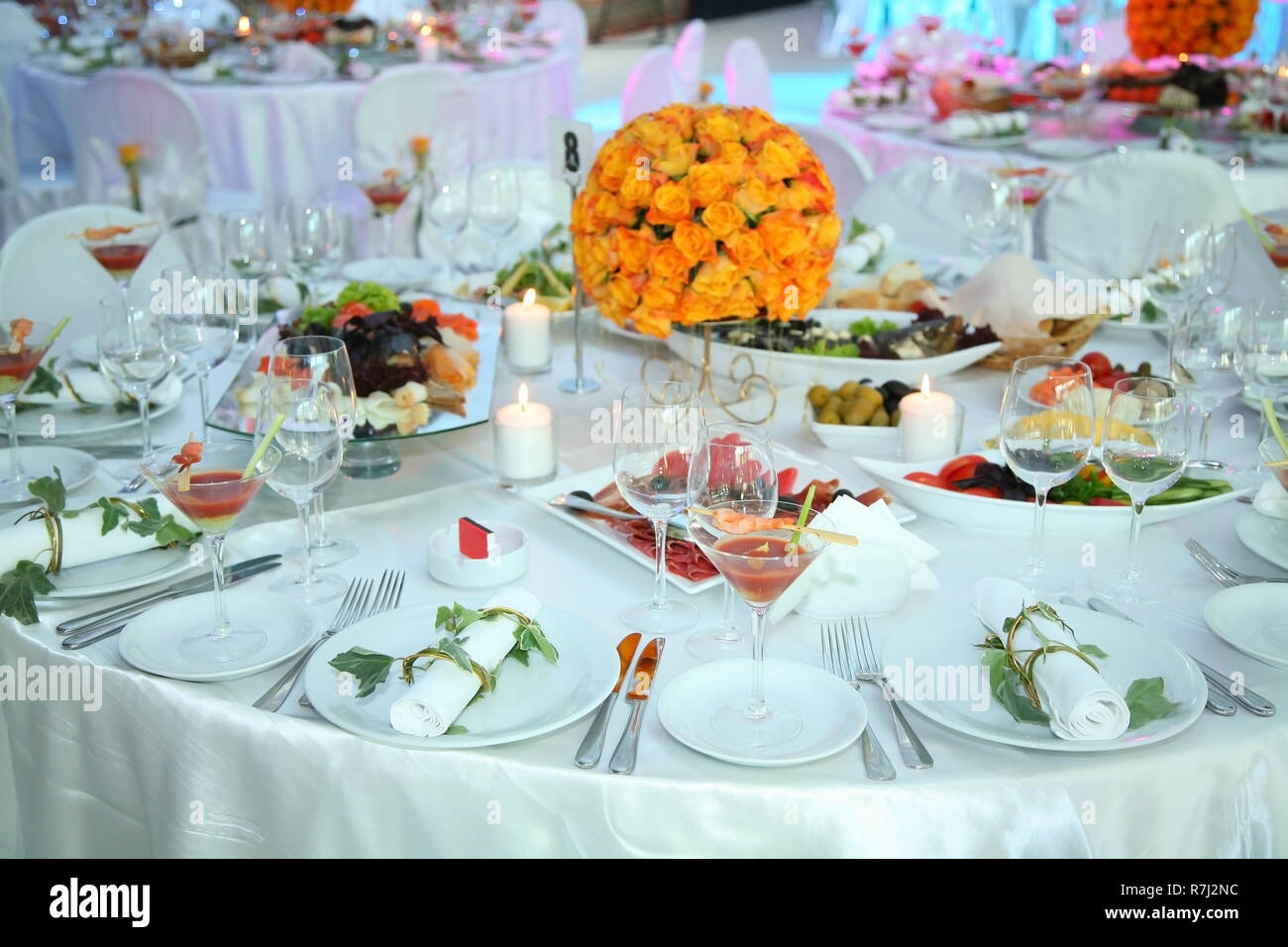 Holiday table setting decorated with flowers and candles Stock Photo ...