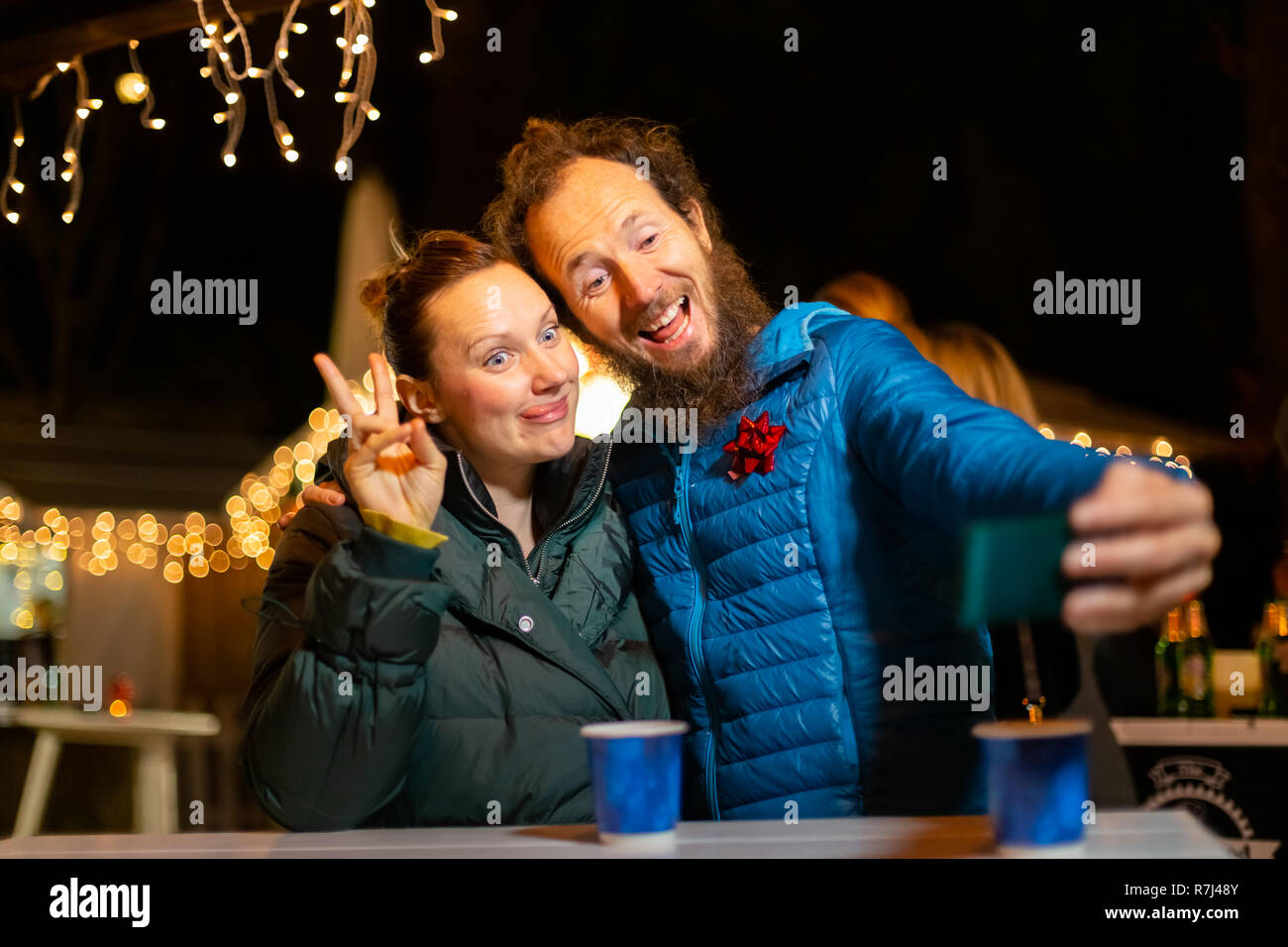 Couple taking selfie at traditional Christmas market, Zagreb, Croatia. Stock Photo