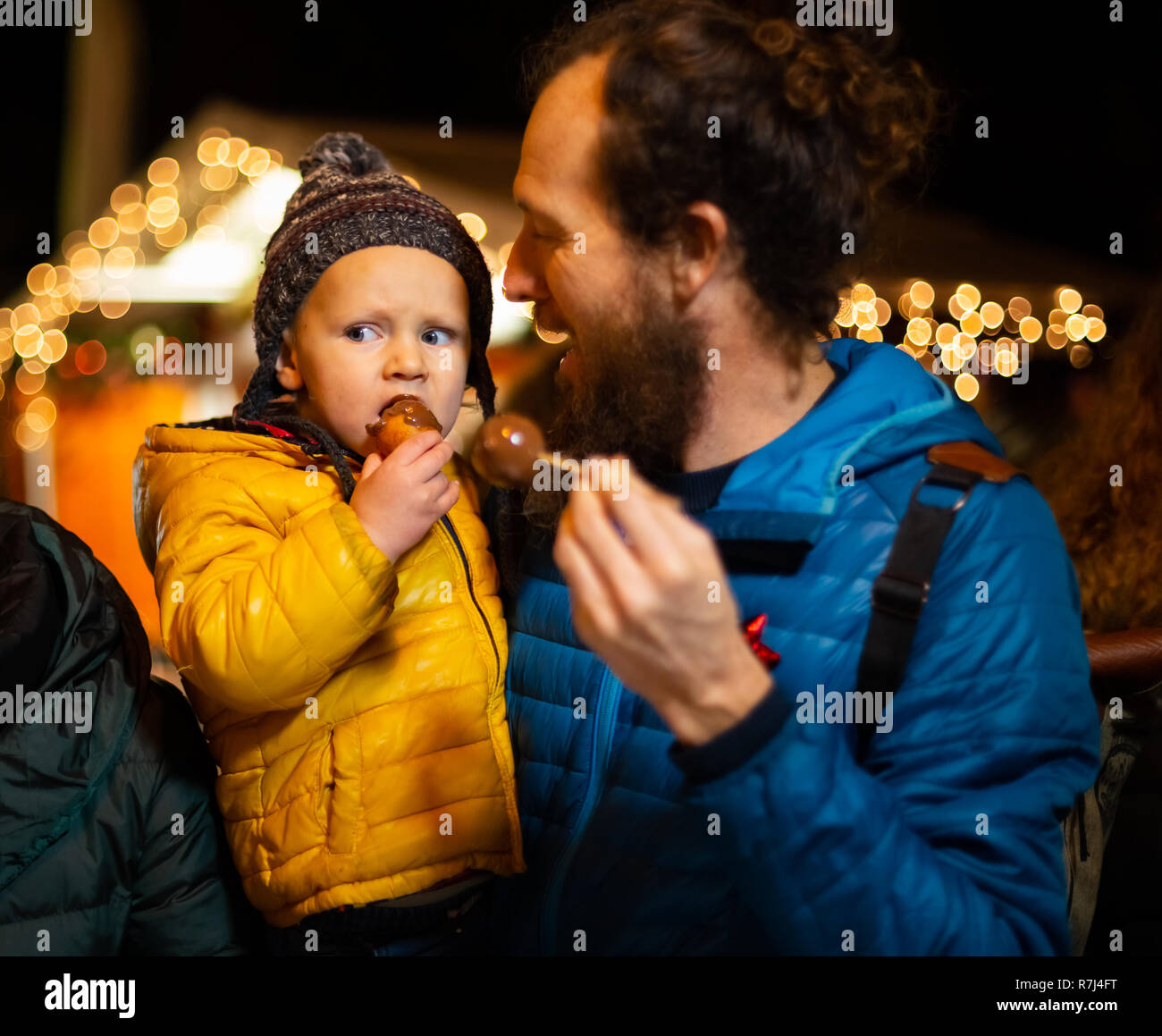 Father and son enjoying traditional food at Christmas market in Zagreb, Croatia. Stock Photo