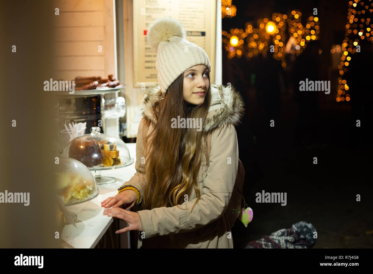 Beautiful teenager in front of traditional Christmas market food stand, Zagreb, Croacia. Stock Photo