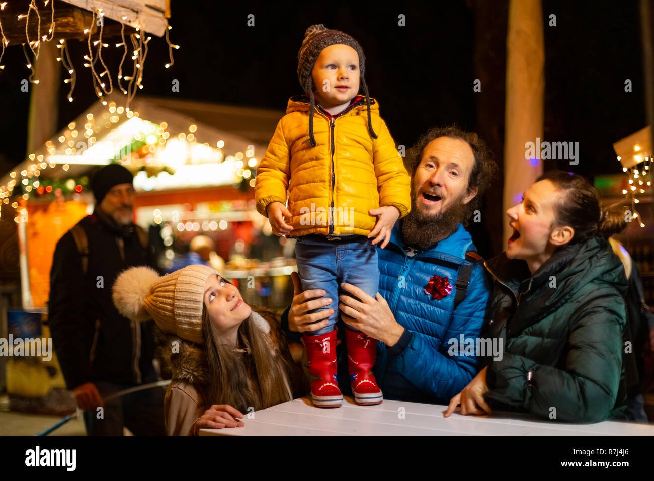 Family enjoying traditional Christmas market in Zagreb, Croatia. Stock Photo