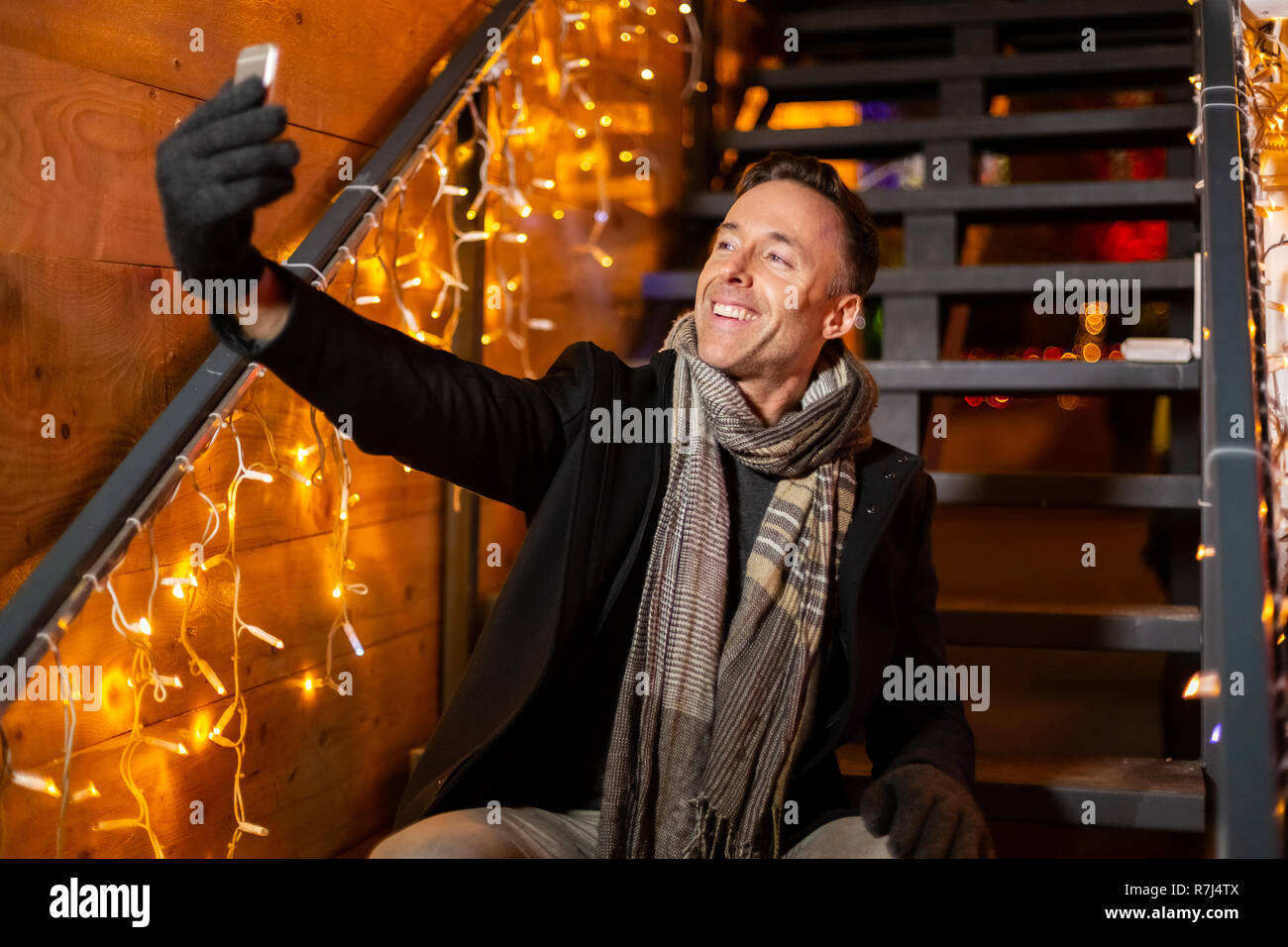 Man talking selfie at Christmas market, Zagreb, Croatia. Stock Photo