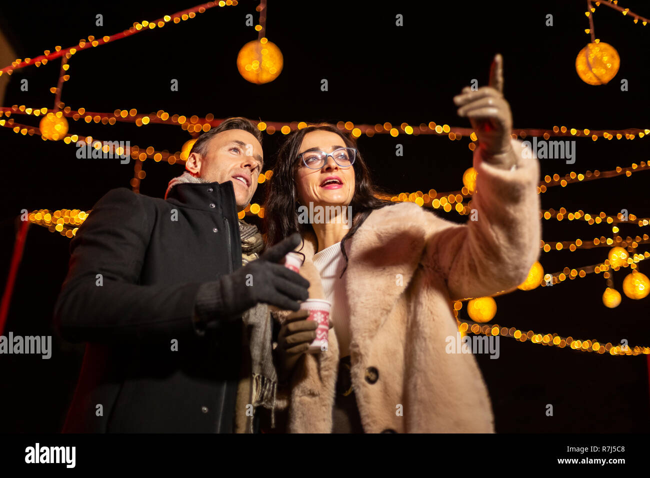 Couple pointing to decoration at Christmas market. Zagreb, Croatia. Stock Photo