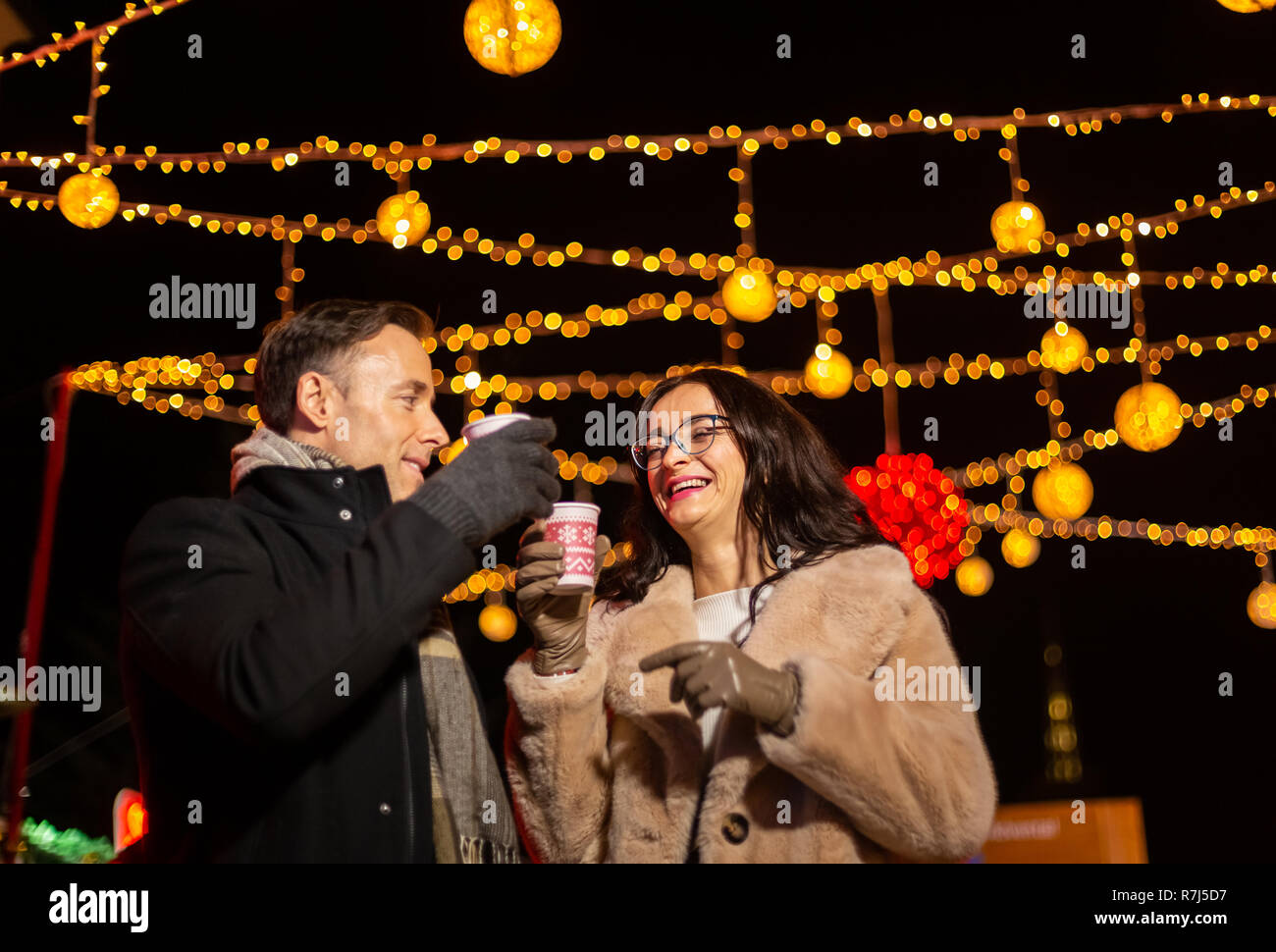 Couple cheering with mlled wine at Christmas market. Zagreb, Croatia. Stock Photo