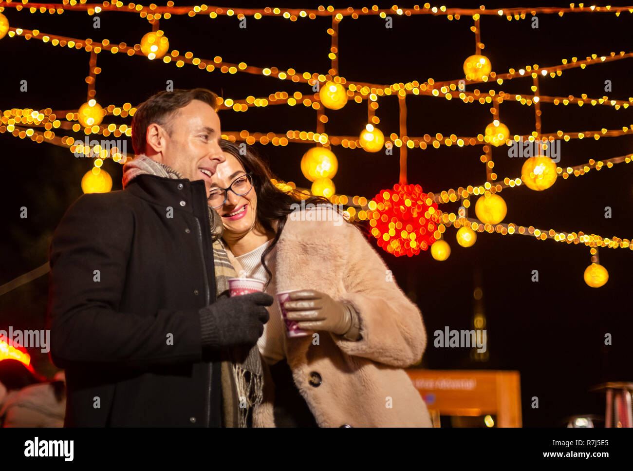 Woman leaning head on man shoulder at Christmas market. Zagreb, Croatia. Stock Photo