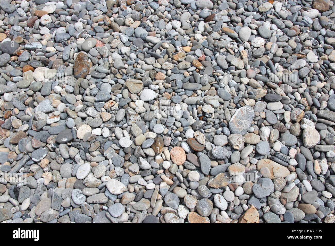 Pebbly beach background from Crete, Greece. Shingle beach. Stock Photo