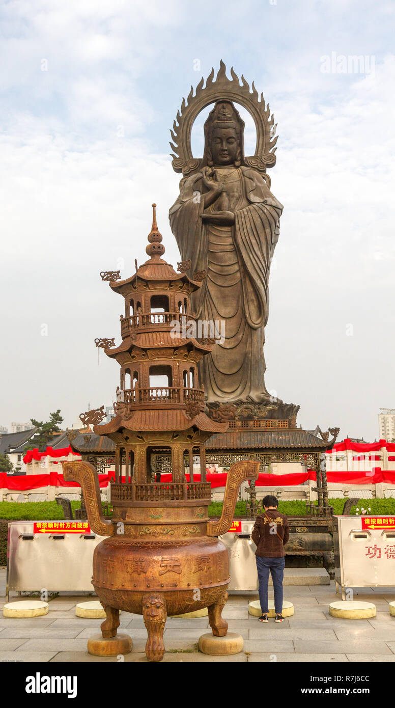 Vertical Photo Of Guanying Buddha Statue At Guiyuan Buddhist Temple In Wuhan Hubei China A Person Is Praying In Front Of Statue Stock Photo Alamy