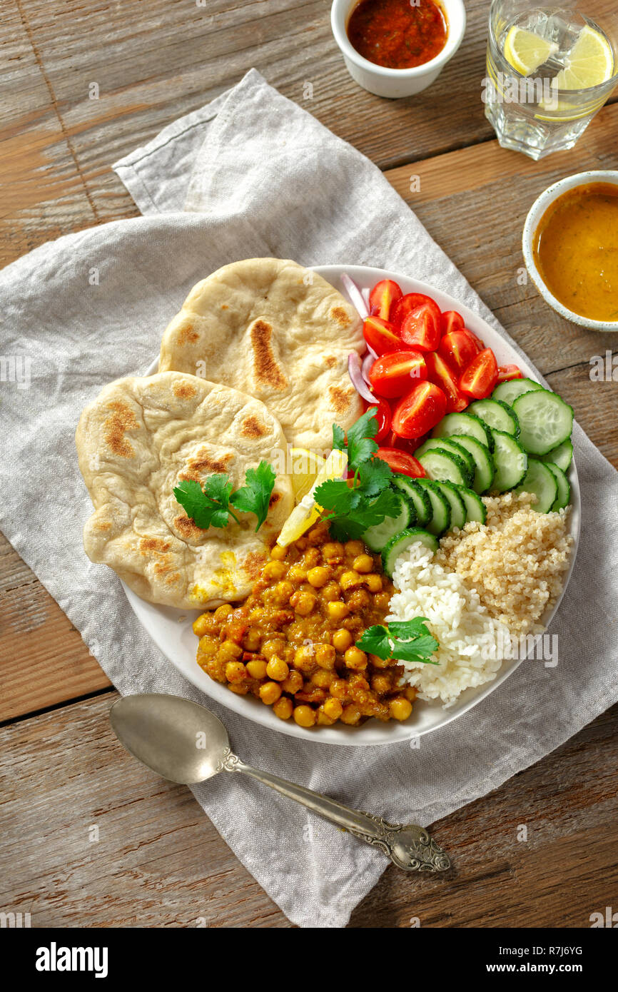 Quinoa, chickpeas, rice, vegetable vegetarian buddha bowl on wooden table top view. Healthy food Stock Photo