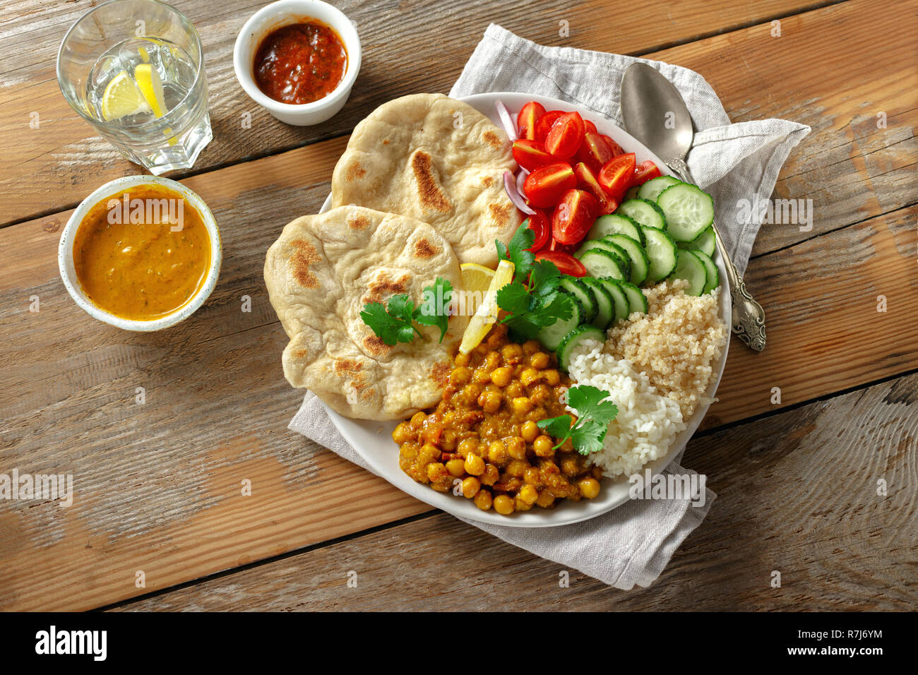 Quinoa, chickpeas, rice, vegetable vegetarian buddha bowl on wooden table top view. Healthy food Stock Photo