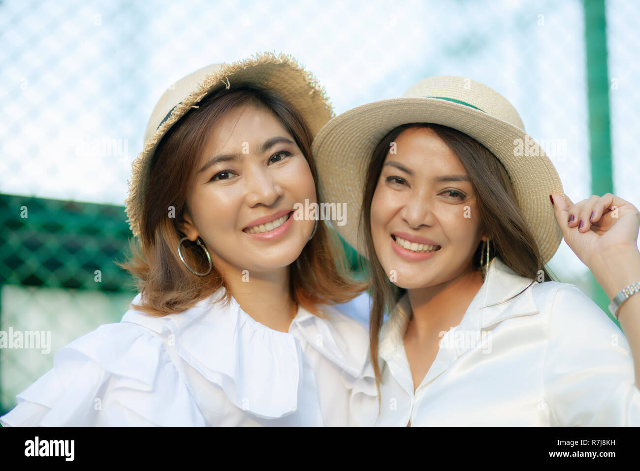 close up face of toothy smiling face asian younger woman vacation relaxing Stock Photo