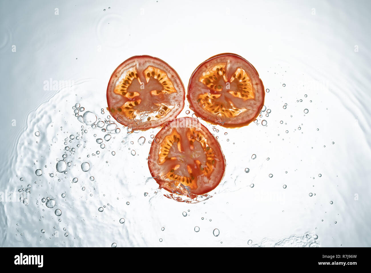 Tomatoes Water Splash on white background Stock Photo - Alamy