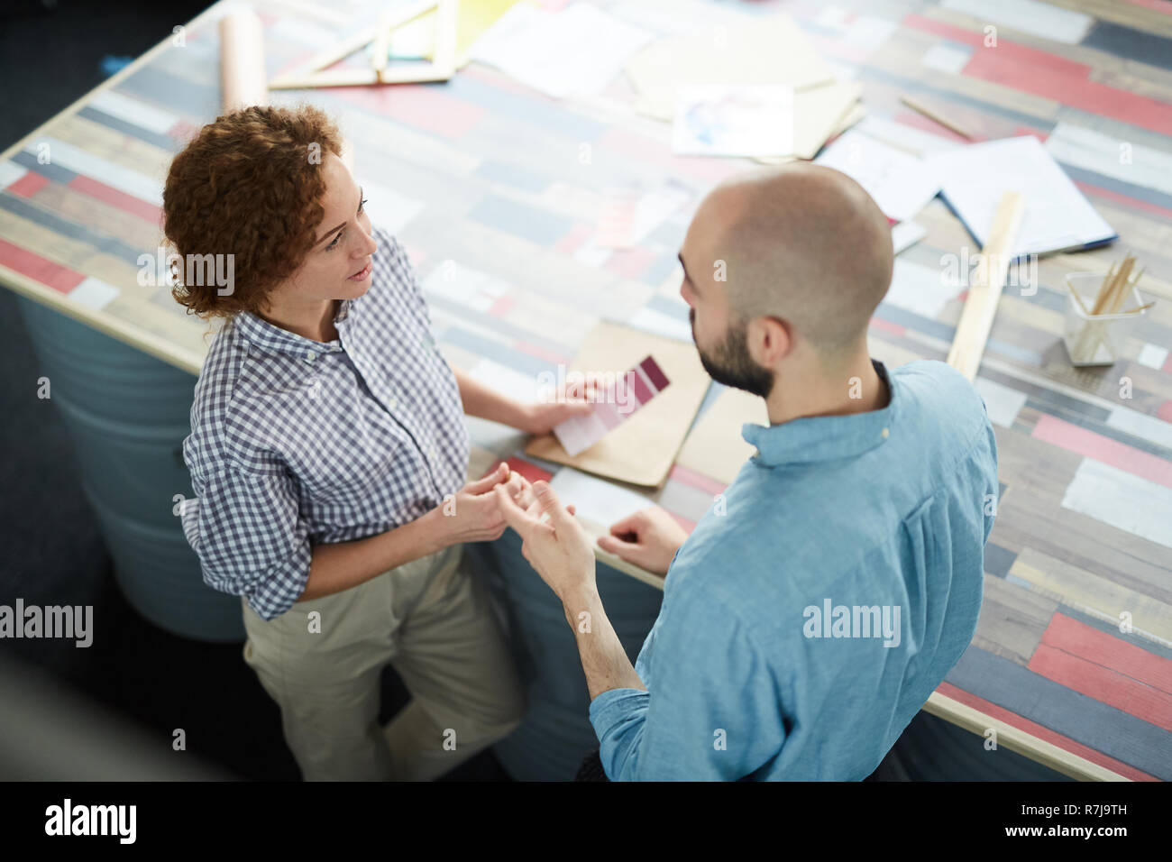 Creative designers discussing new project in studio Stock Photo