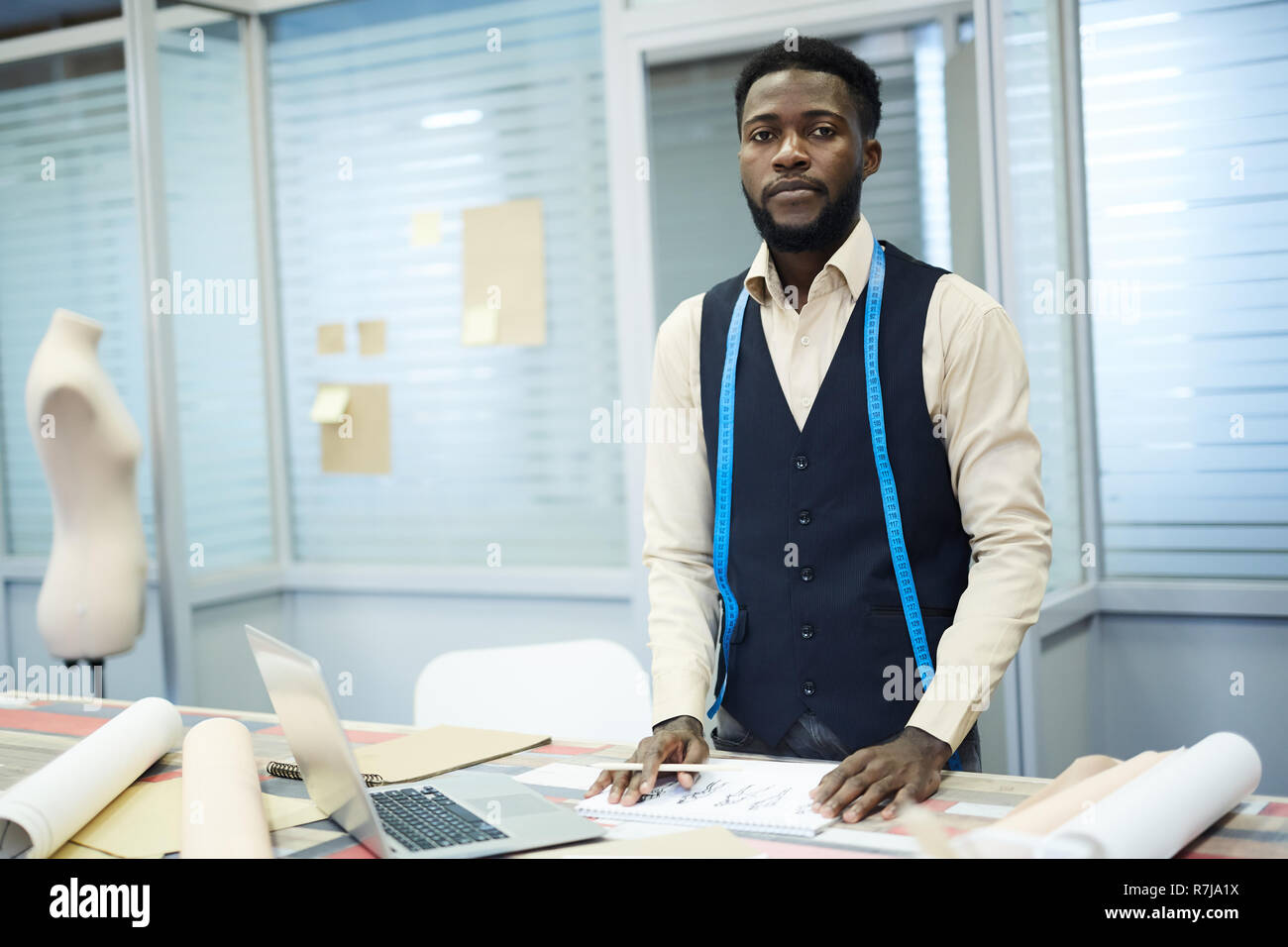 Serious dressmaker working in own studio Stock Photo