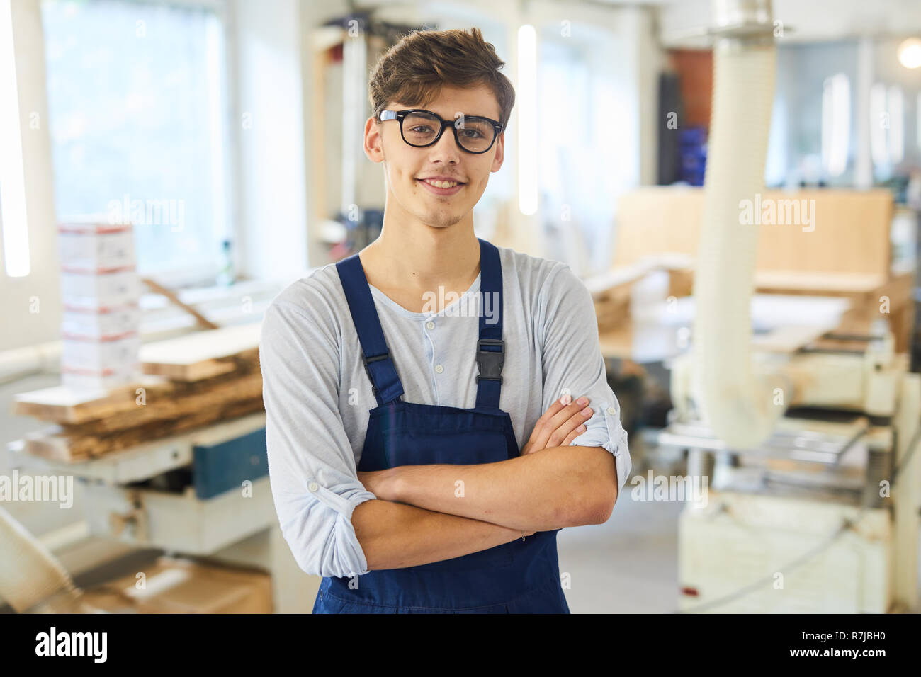 Smiling young joiner in uniform Stock Photo