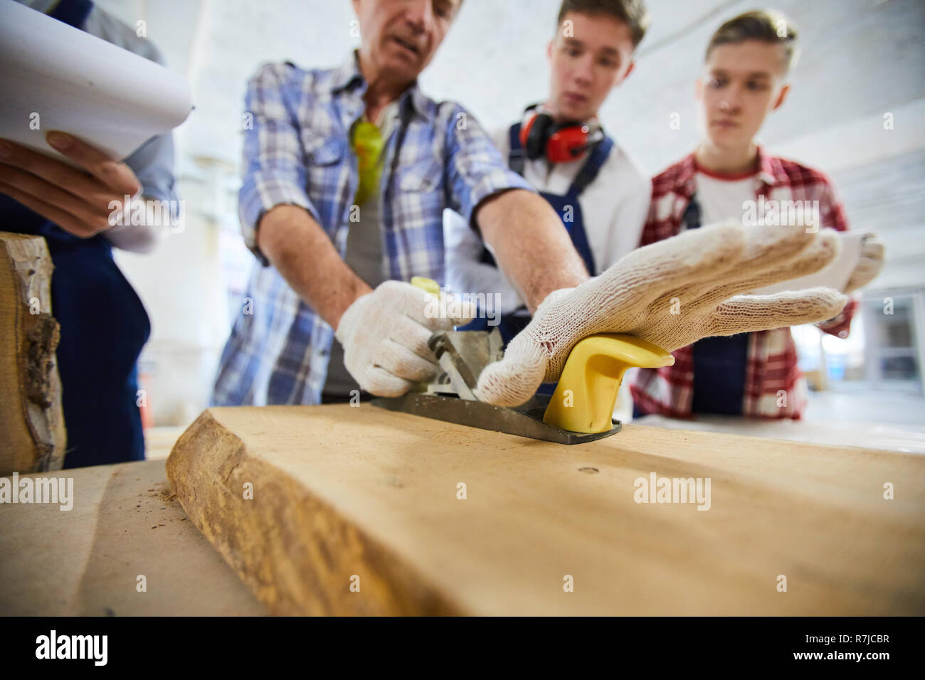 Processing surface of wood in workshop Stock Photo