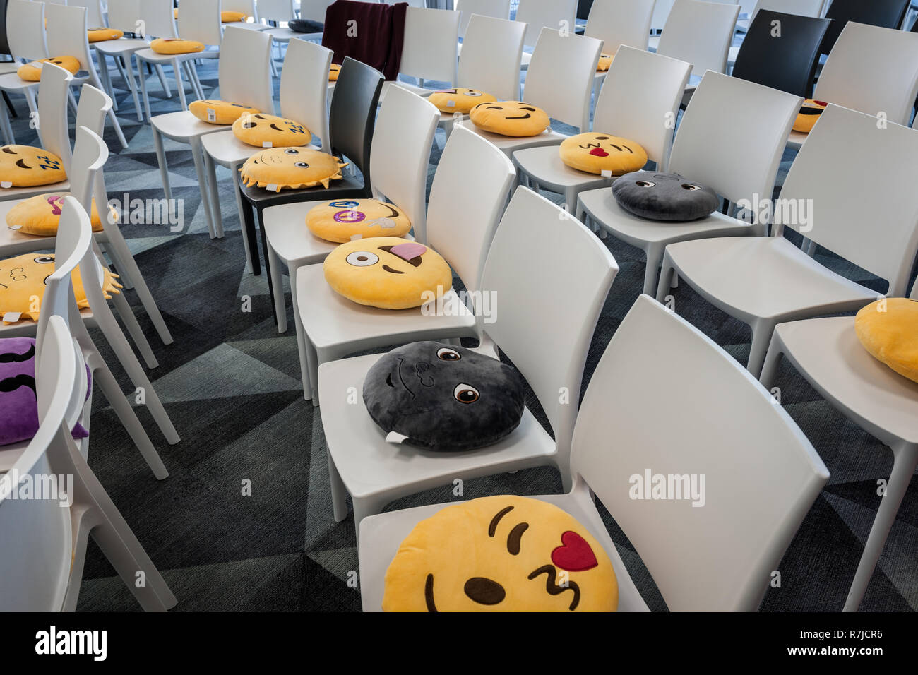 emoji cushions on chairs Stock Photo