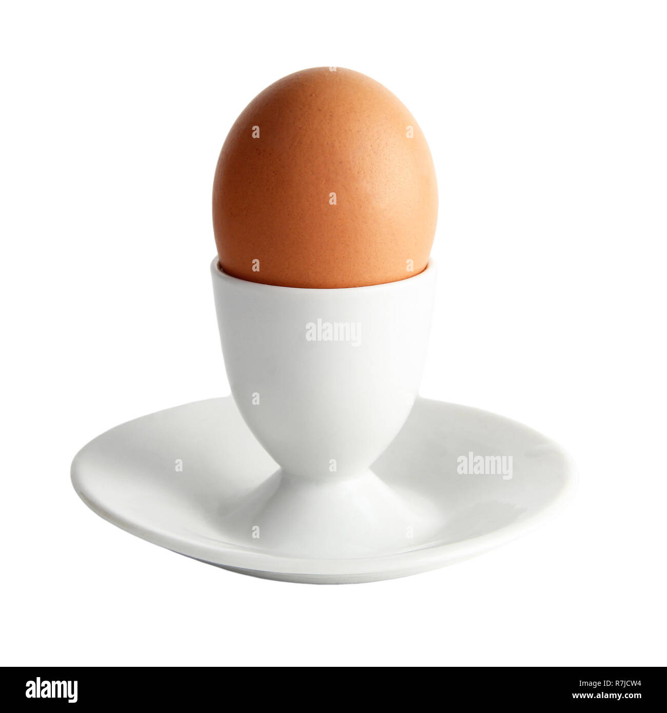 brown egg on a stand isolated on white background Stock Photo - Alamy