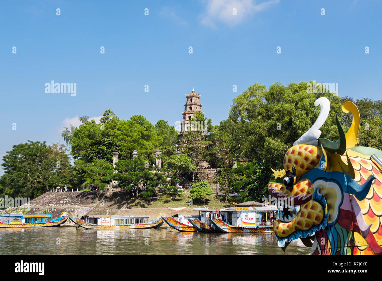 View of Thien Mu Pagoda from a tourists' dragon boat sailing on the Song Huong or Perfume River. Hue, Thua Thien–Hue, Vietnam, Asia Stock Photo