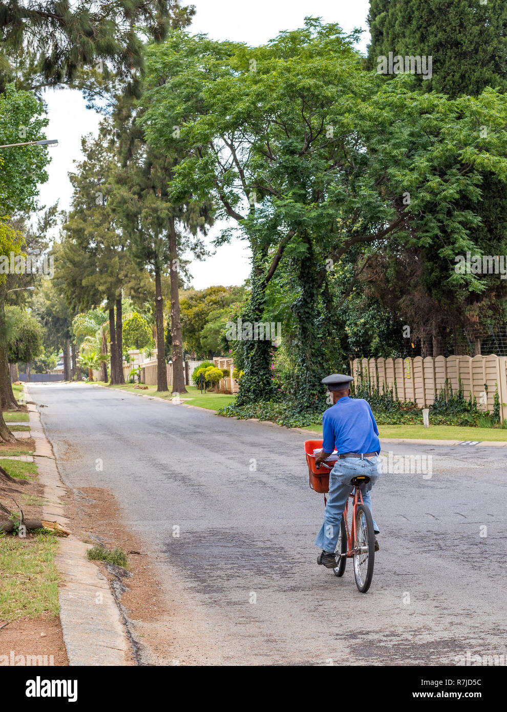 Johannesburg, South Africa an unidentified postman does hand deliveries of mail on bicycle in