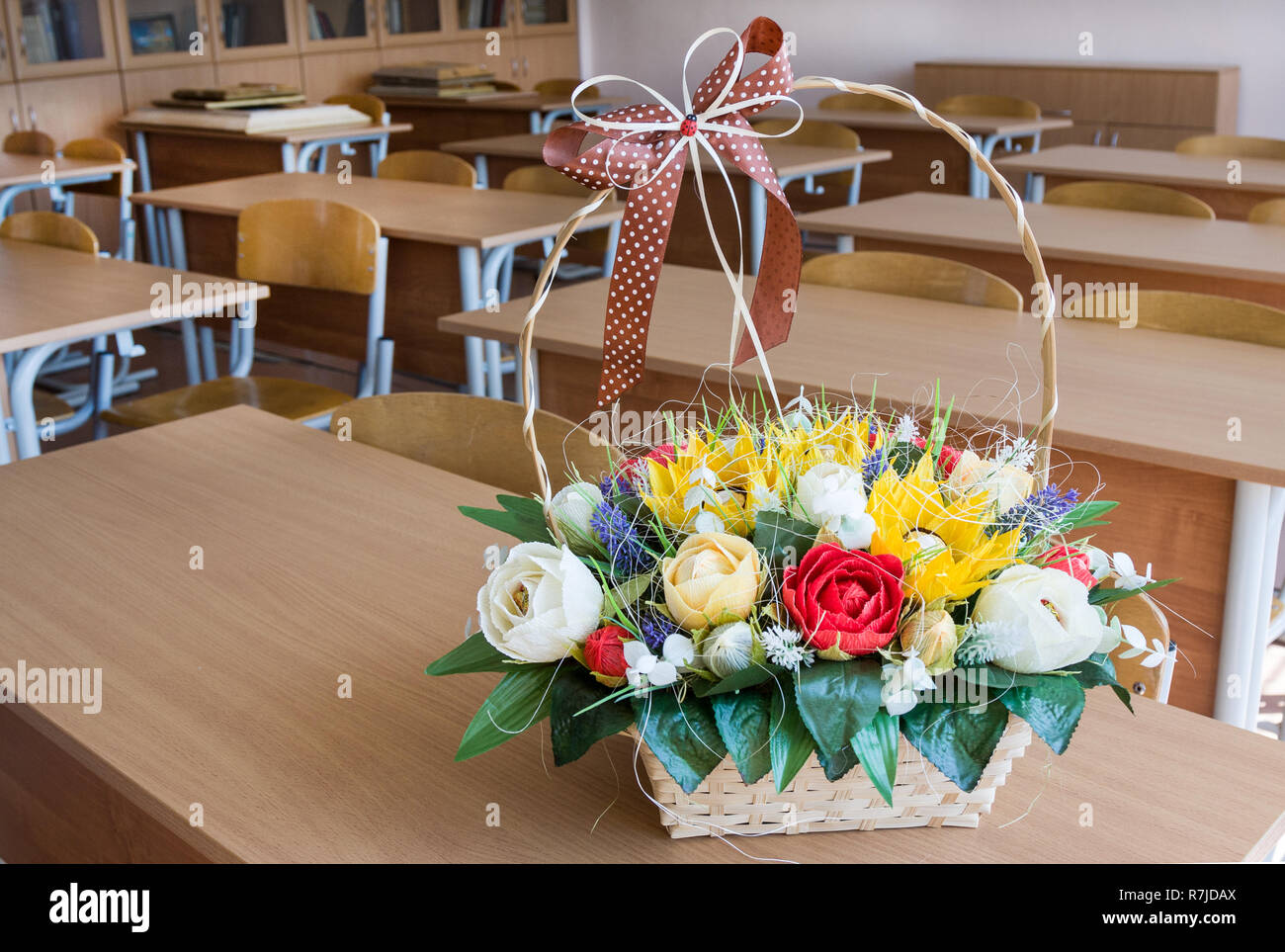 Basket with paper flowers on desk in classroom Stock Photo Alamy