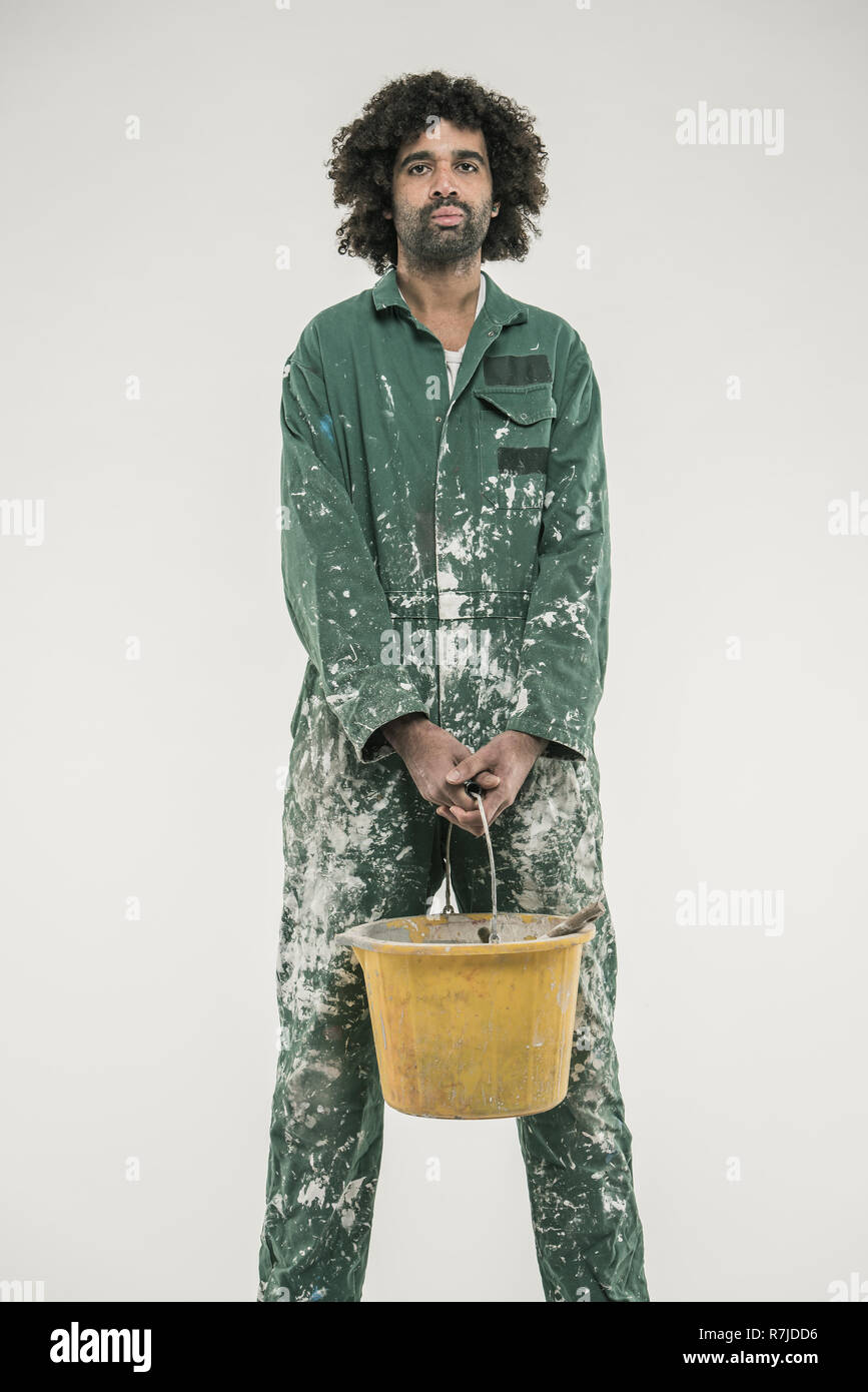 Black male in paint overalls with bucket Stock Photo