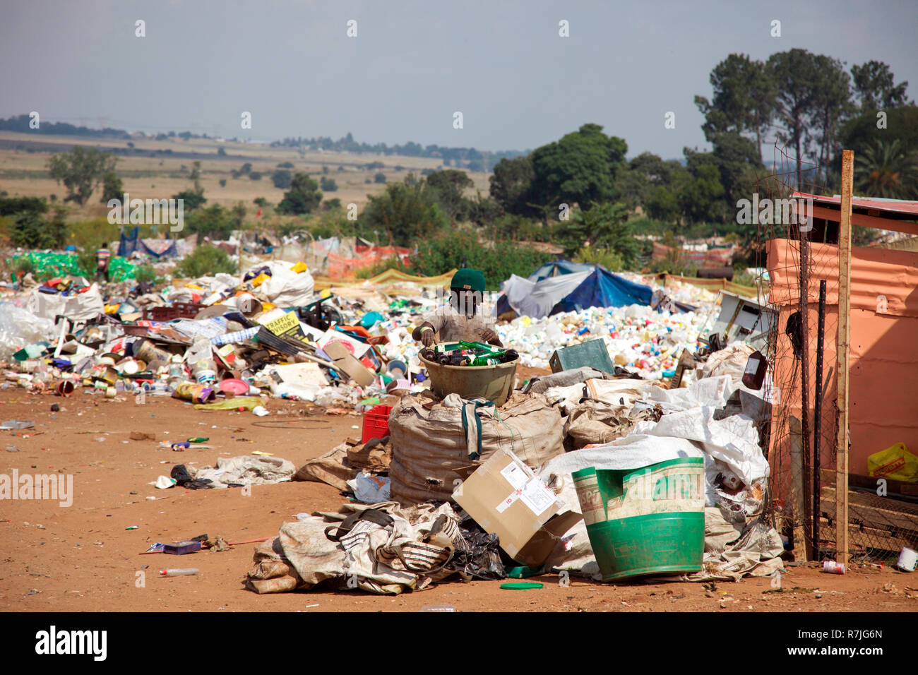 Resident Zulu man separating out glass bottles on the Mooiplaas rubbish dump, Johannesburg Stock Photo