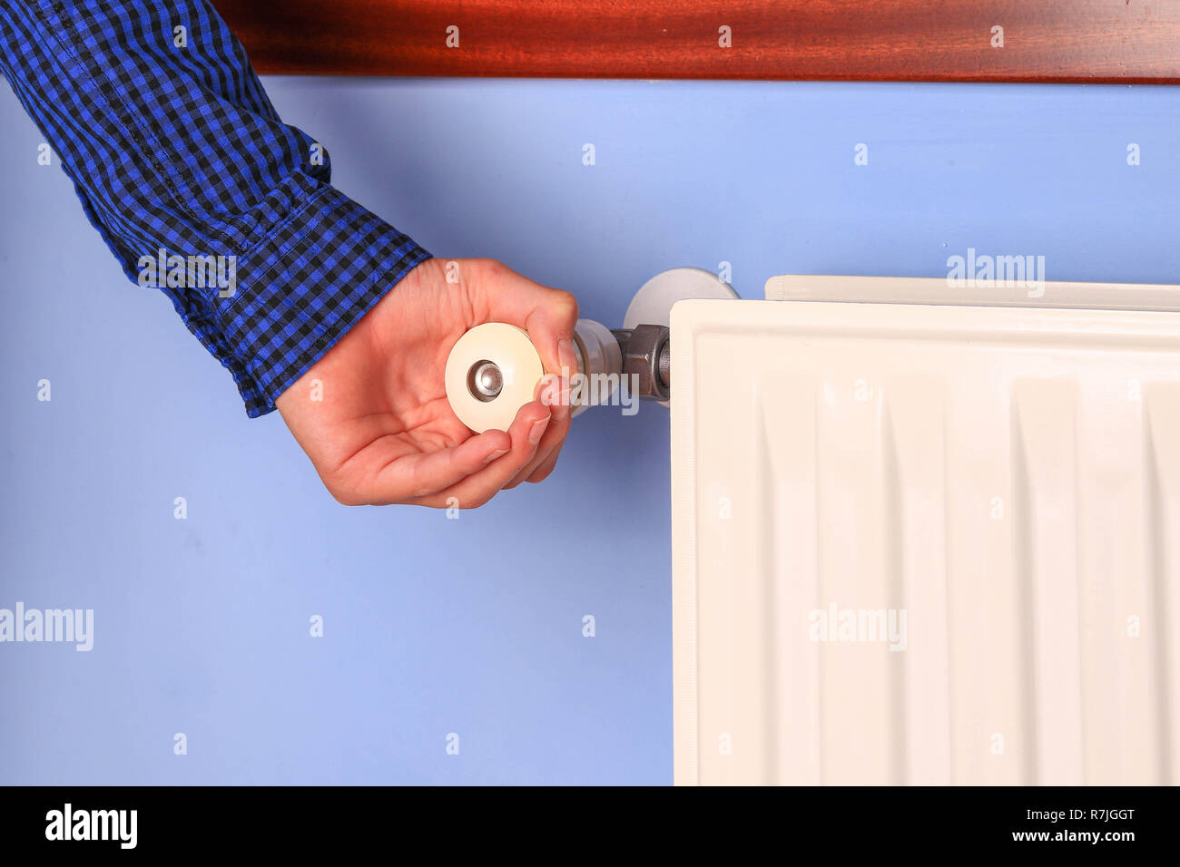 Hand Adjusting The Knob Of Heating Radiator Stock Photo Alamy
