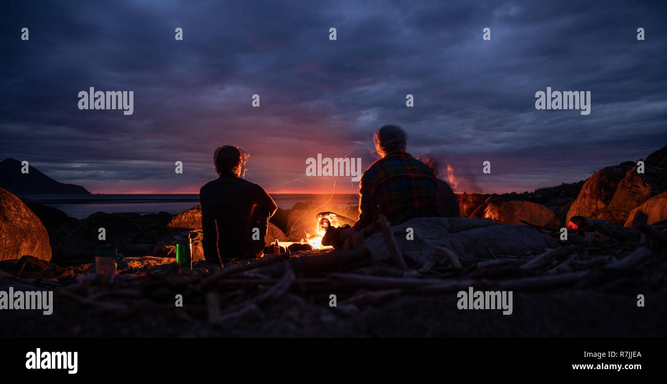 Campfire on the beach, with sunset. Long exposure. Stock Photo