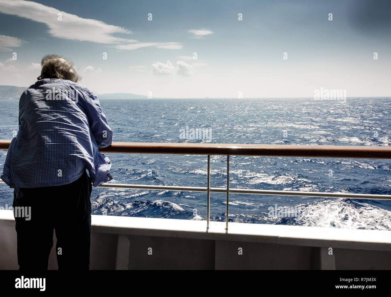 Rear view of senior man on ship Stock Photo