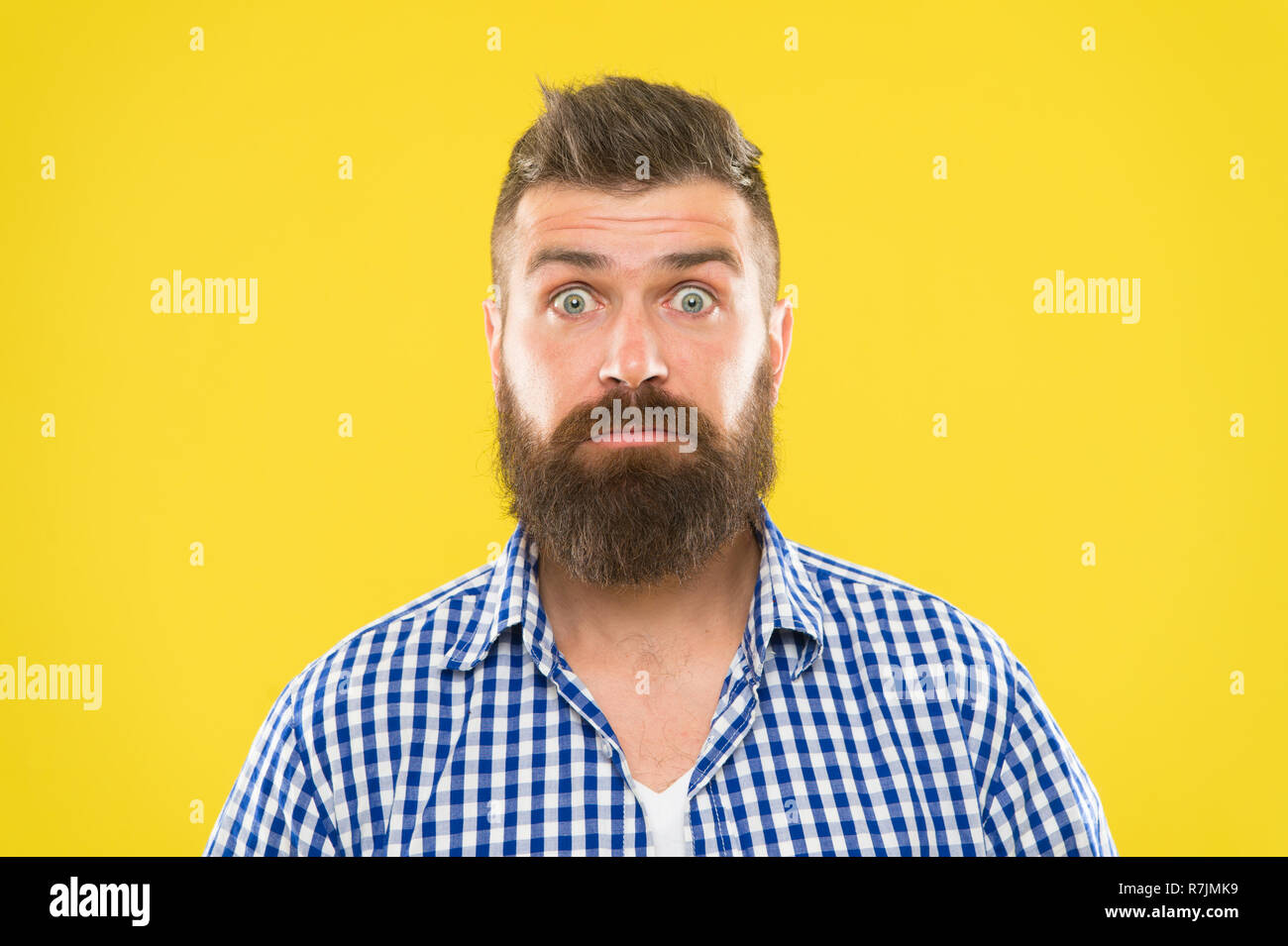 Surprising news. Man bearded hipster wondering face yellow background close up. Guy surprised face expression. Hipster with beard and mustache emotional surprised expression. Rustic surprised macho. Stock Photo